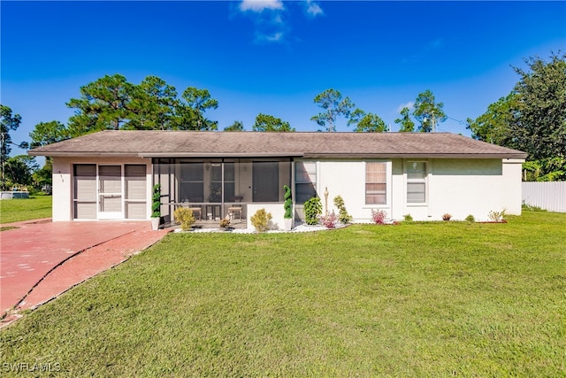 ranch-style home with a front yard and a sunroom