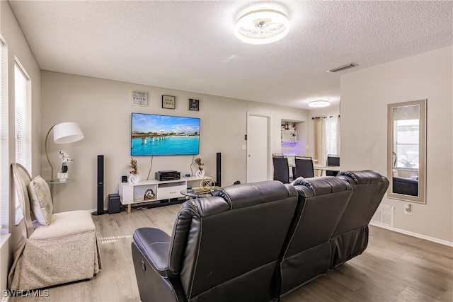 living room with hardwood / wood-style flooring and a textured ceiling