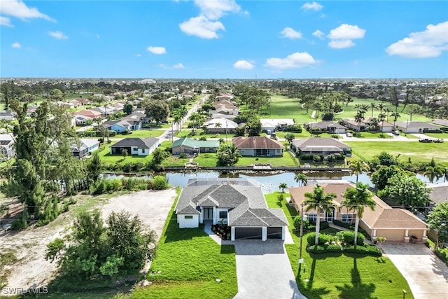 drone / aerial view with a water view and a residential view