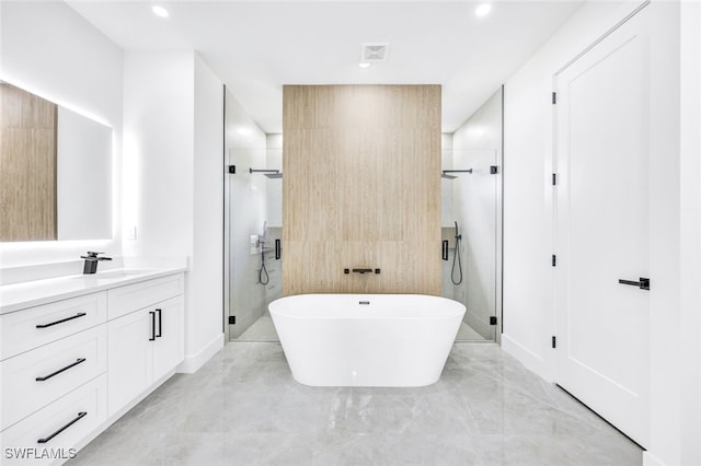 bathroom with visible vents, a stall shower, a soaking tub, and vanity