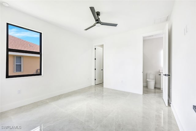 unfurnished bedroom featuring connected bathroom, a ceiling fan, and baseboards