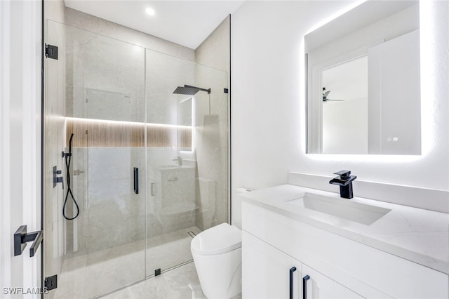 bathroom featuring a shower stall, vanity, and toilet