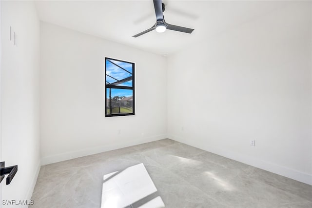 empty room with ceiling fan and baseboards