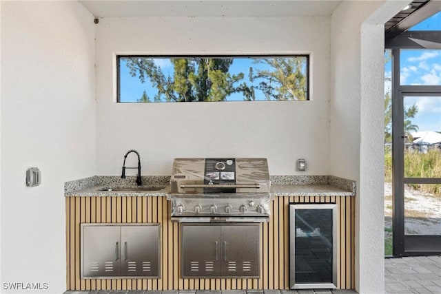 interior space featuring beverage cooler and a sink