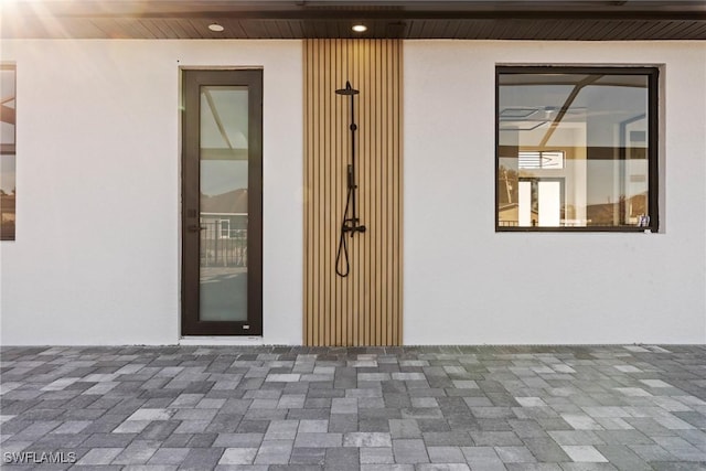 property entrance featuring stucco siding