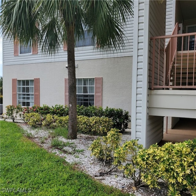 view of side of home featuring a balcony