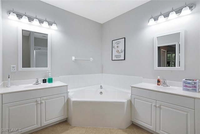 bathroom featuring a washtub, tile patterned floors, and vanity