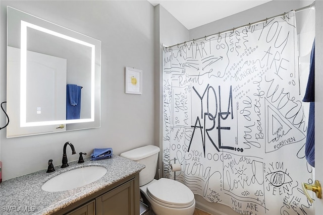 full bathroom featuring vanity, shower / tub combo with curtain, and toilet