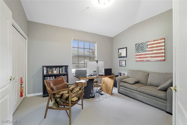 office area featuring light colored carpet and vaulted ceiling