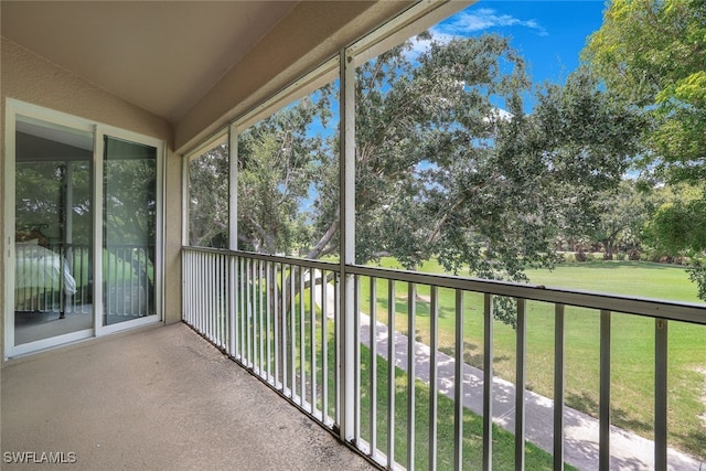 unfurnished sunroom featuring vaulted ceiling