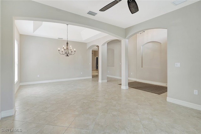 unfurnished room with a raised ceiling, light tile patterned flooring, and ceiling fan with notable chandelier