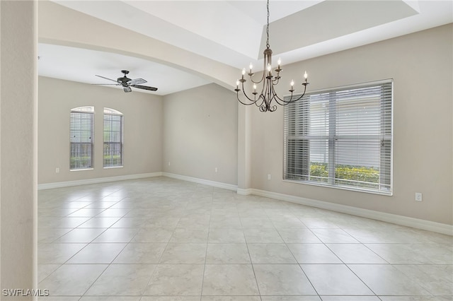 tiled empty room with ceiling fan with notable chandelier