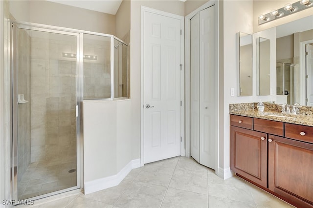 bathroom featuring vanity and an enclosed shower