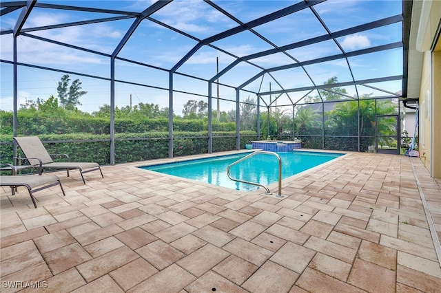 view of swimming pool with a patio area, a lanai, and an in ground hot tub