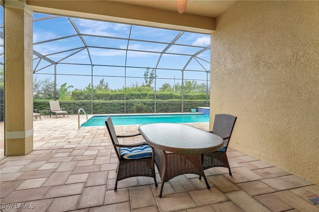 view of pool with a patio area and a lanai