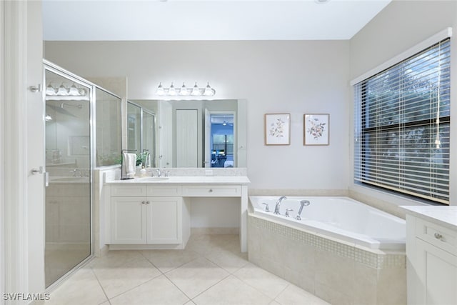 bathroom featuring vanity, shower with separate bathtub, and tile patterned flooring