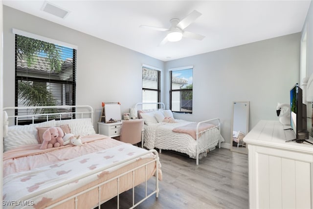 bedroom featuring hardwood / wood-style flooring and ceiling fan