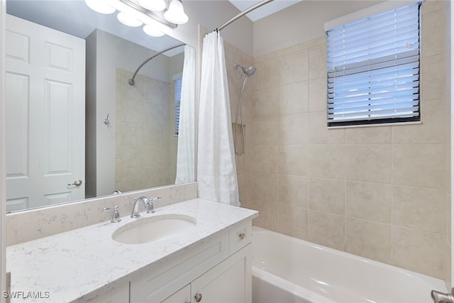 bathroom featuring vanity and shower / bath combination with curtain