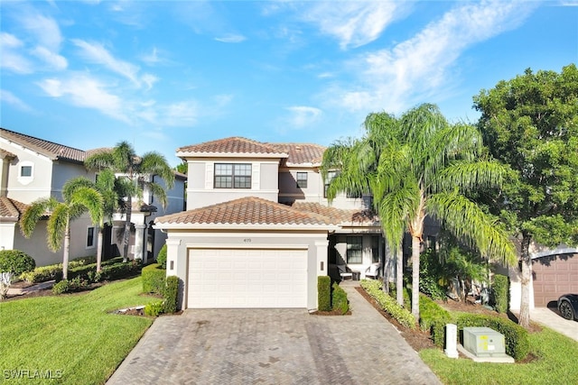 mediterranean / spanish-style home featuring a garage and a front lawn