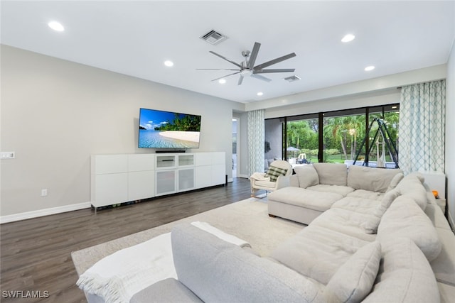 living room featuring ceiling fan and dark hardwood / wood-style floors