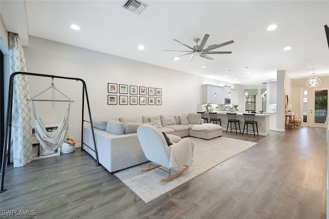 living room featuring dark hardwood / wood-style floors and ceiling fan