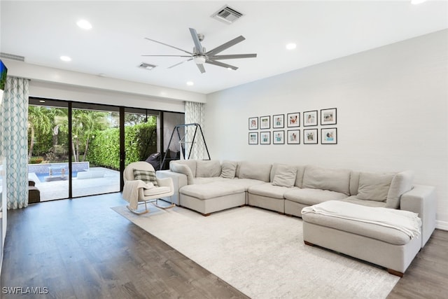 living room with hardwood / wood-style floors and ceiling fan