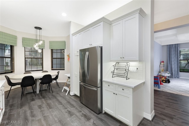 4119 Zelkova Ct, Naples, FL 34119 - kitchen with freestanding refrigerator, wood finished floors, white cabinets, a chandelier, and pendant lighting
