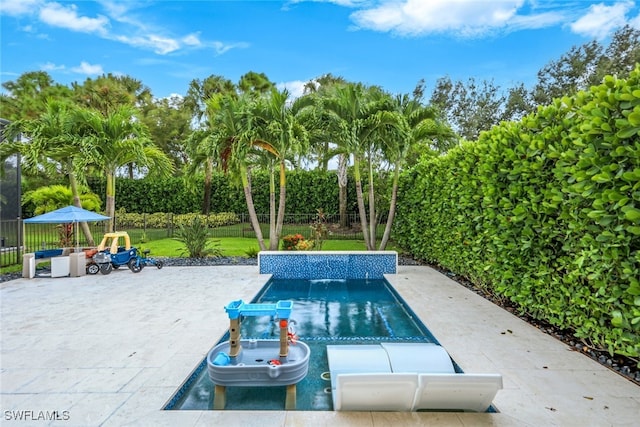 view of swimming pool with a yard and a patio