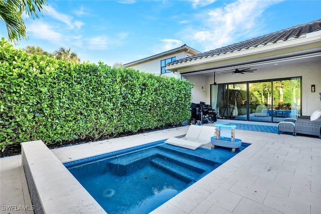 view of swimming pool with ceiling fan, a patio area, and an outdoor living space