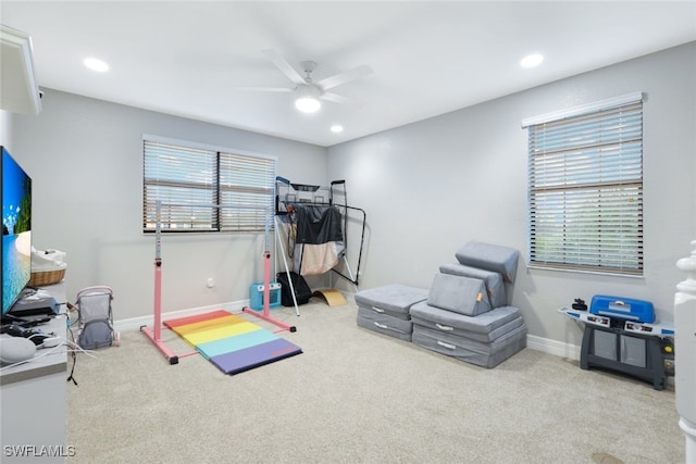 workout room featuring ceiling fan and carpet