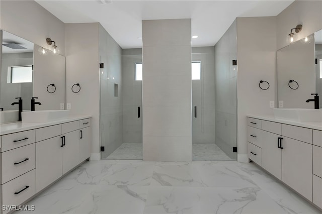 bathroom with vanity and a shower with shower door