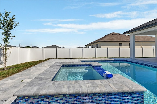 view of swimming pool featuring an in ground hot tub