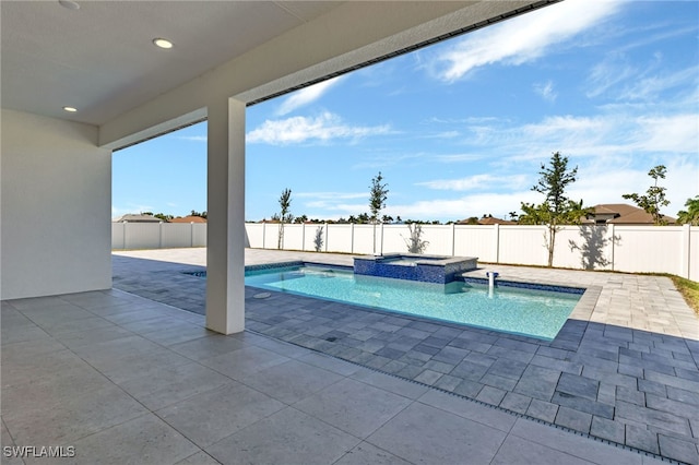 view of swimming pool with a patio and an in ground hot tub