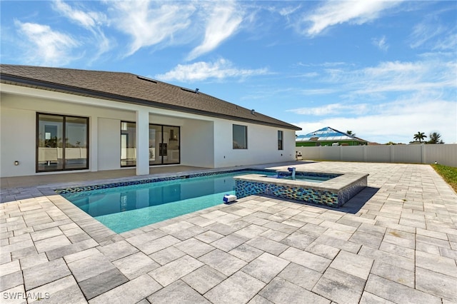 view of pool with a patio and an in ground hot tub