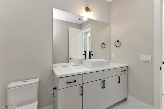 bathroom with vanity and toilet