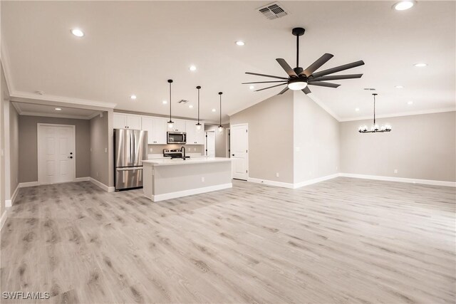 unfurnished living room featuring lofted ceiling, ceiling fan with notable chandelier, light hardwood / wood-style floors, and ornamental molding