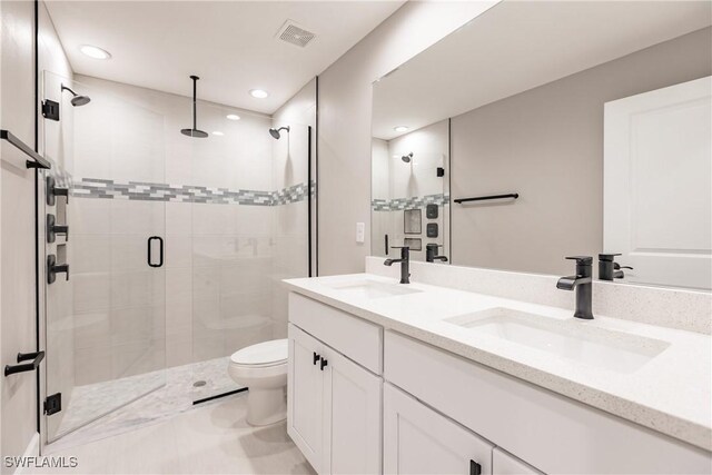 bathroom with vanity, toilet, and an enclosed shower