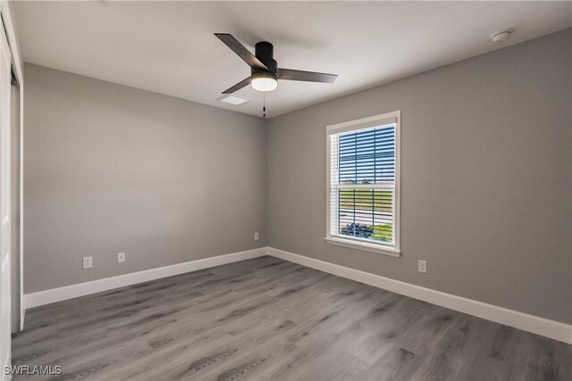 spare room featuring hardwood / wood-style floors and ceiling fan