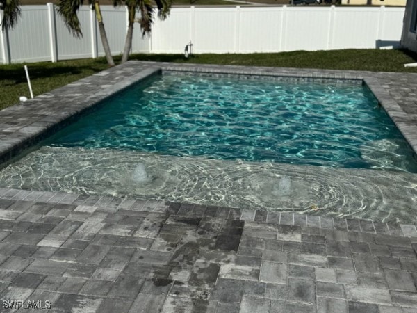 view of swimming pool with a fenced backyard