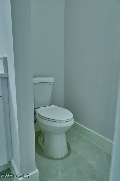 bathroom featuring tile patterned flooring and toilet