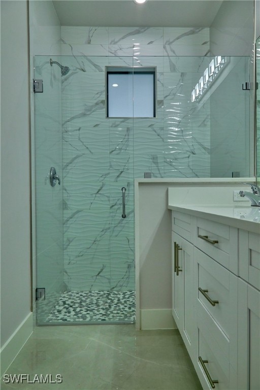 bathroom with vanity, tile patterned floors, and a shower with door