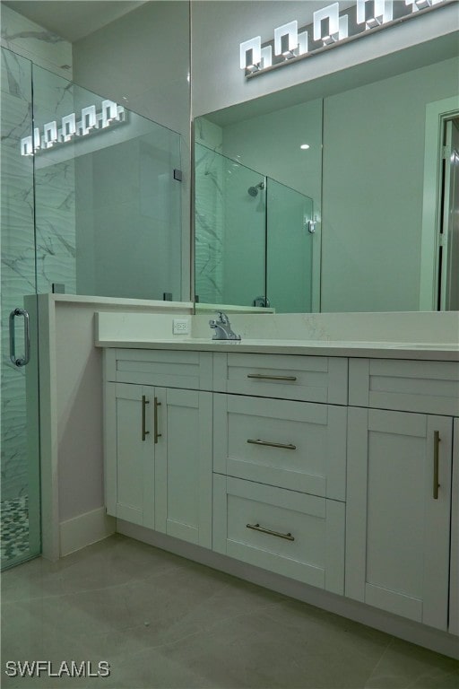 bathroom featuring vanity and a shower with door