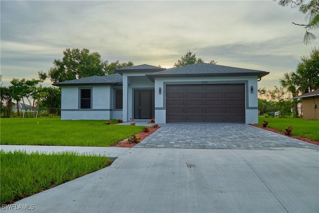 view of front facade with a lawn and a garage