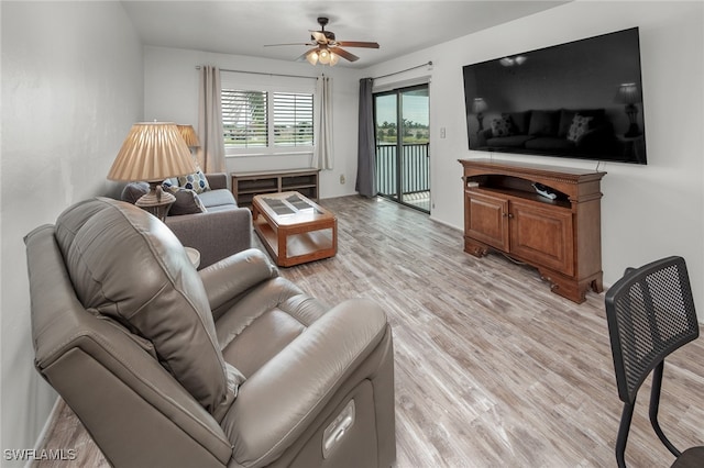 living room featuring light hardwood / wood-style floors and ceiling fan