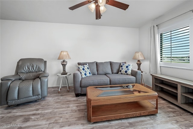 living room featuring wood-type flooring and ceiling fan