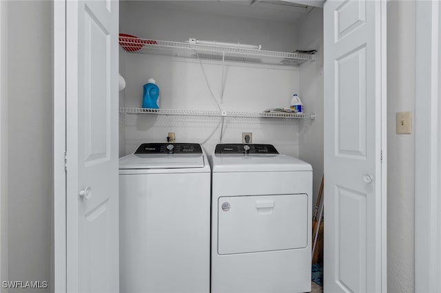 clothes washing area with washer and dryer