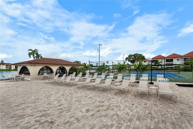 view of pool with tennis court