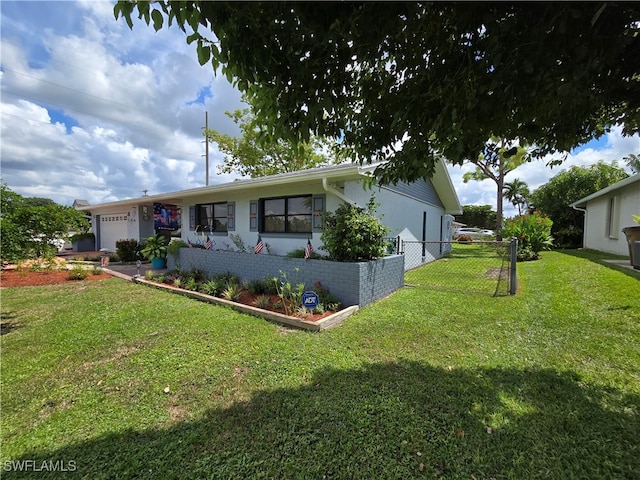 view of front of home with a front lawn and a garage