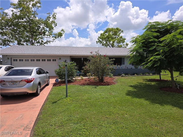 ranch-style home featuring a garage and a front lawn