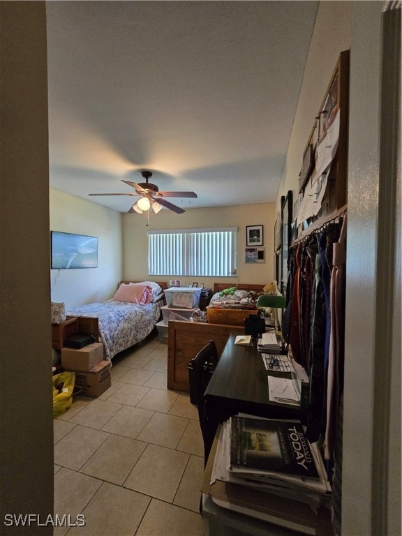 bedroom with ceiling fan and light tile patterned flooring